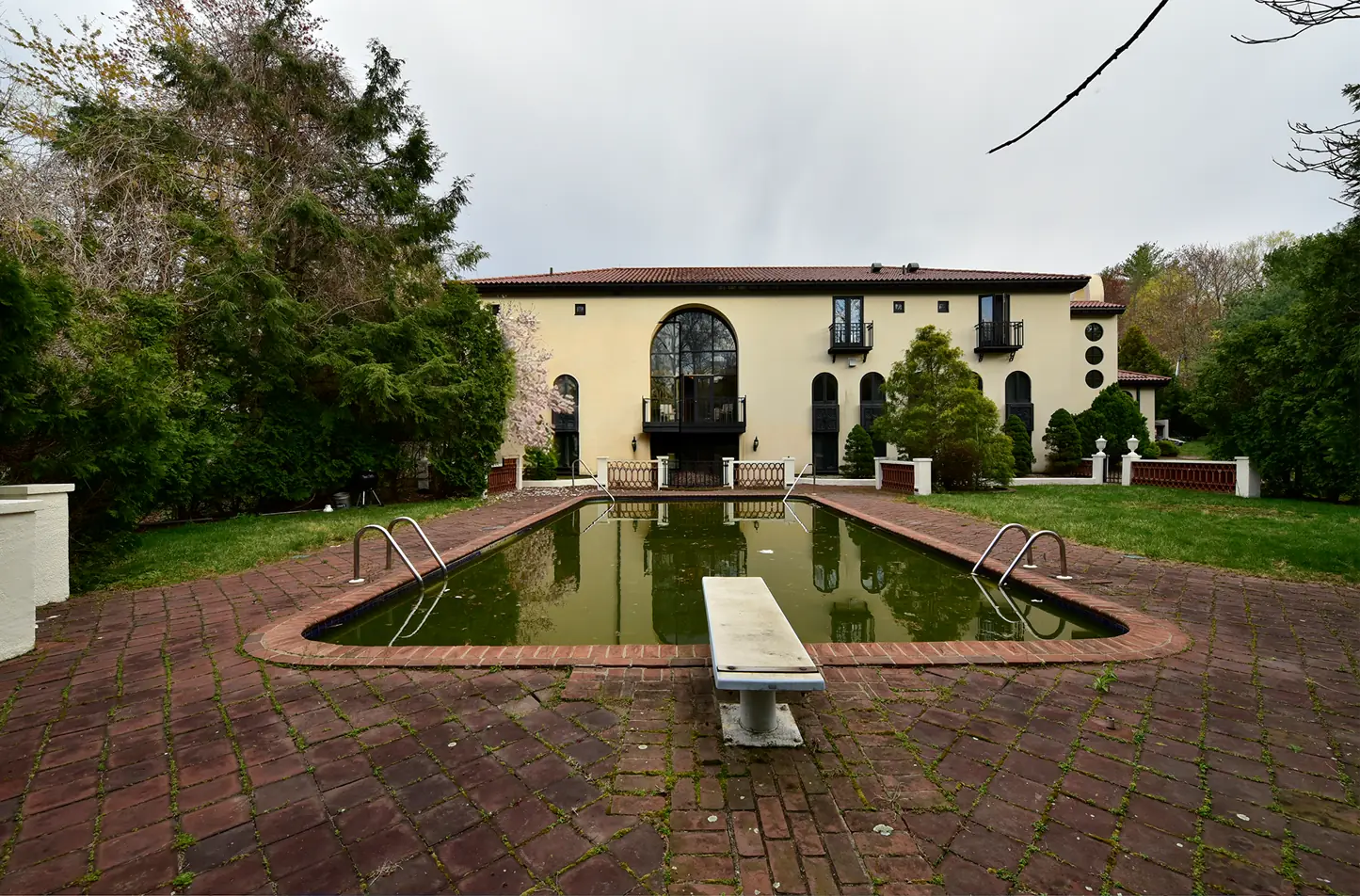 Pool courtyard, sky replaced and pool water turned blue, before editing